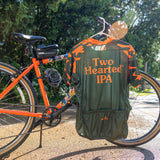 Olive green bike jersey with orange and green camo on the sleeves, with orange collar. The back has large Two Hearted IPA logo on the back, and an orange Bell's logo above it. The back also features Borah logo in orange over middle pocket.