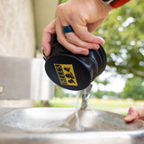 black rubber collapsible dog bowl with yellow Bell's logo on bottom. Also has carabiner clip