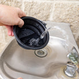 black rubber collapsible dog bowl with yellow Bell's logo on bottom. Also has carabiner clip