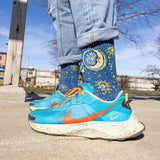 navy blue ribbed sock with yellow star pattern, featuring Oberon Eclipse logo, moon and sun, in full color on the upper portion. Yellow top with QEJA Q