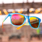 Sunglasses with transparent blue rims and orange lenses, with Oberon text and logo on the temple exterior.