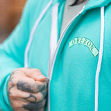 Teal zip up hoodie hoodie, small teal Oberon banner on the pocket are of the front.