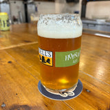 Clear can-shaped glass with Hopslam person logo, filled with Hopslam,