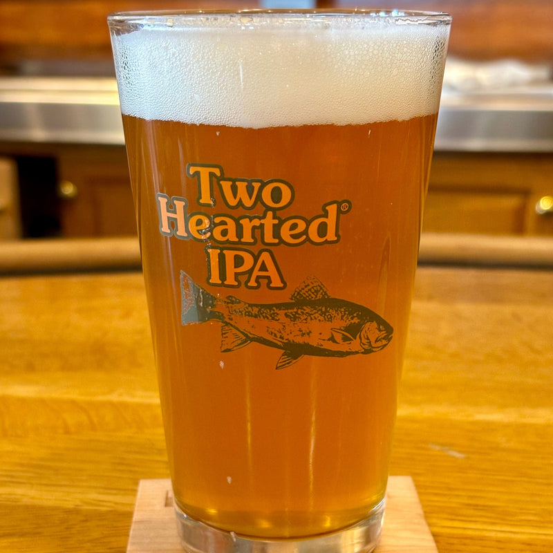 Clear pint glass with green Two Hearted fish and a green Bell’s logo.