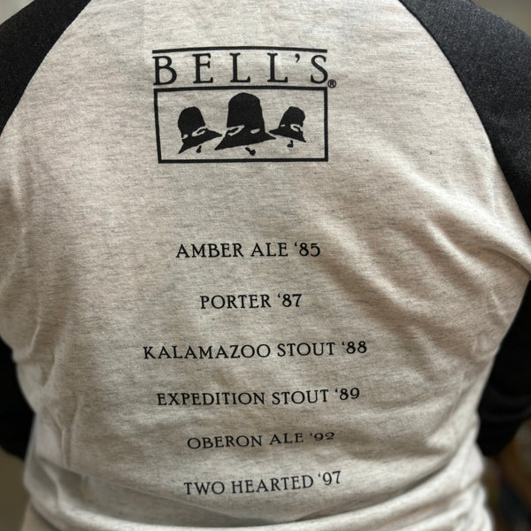 Light grey raglan tee shirt, back image, with vintage logo and 6 brands listed with release years