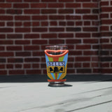 Multi-color glass pint sleeve with 'Bell's' on the sleeve.