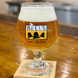 Clear snifter glass with yellow, black and clear Bell's logo. Inspired Brewing tagline in black below.