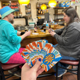 Oberon themed deck of playing cards featuring a sunburst design with orange, blue, yellow, teal, and white around the Oberon sun.