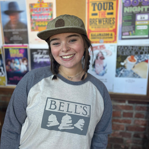 A raglan t-shirt with gray 3/4 sleeves, a white body, and the Bell's logo in gray on the chest.