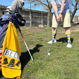 Golden yellow golf towel with Bell's Logo and Inspired Brewing printed on it.