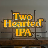 led light with orange lettered "Two Hearted IPA" logo traced in green led light.