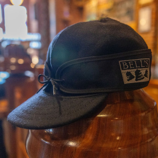 Black stormy kromer style hat with gray Bell's logo embroidered on the side.