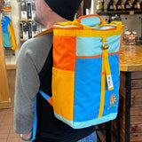 colorful color blocked cooler backpack in Oberon colors, blue, teal, gold, and orange with full color Oberon logo on bottom right