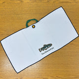 black bordered white waffle knit golf towel with green handle and large full color Two Hearted IPA fish logo embroidered. also features circular black magnet with yellow bell logo
