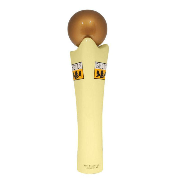 Off-white draft beer tap handle with yellow, black, and white Bell's logo and golden sphere handle topper. "Bell's Brewery, Inc.; Comstock, MI" in small print at the bottom of the tap handle.
