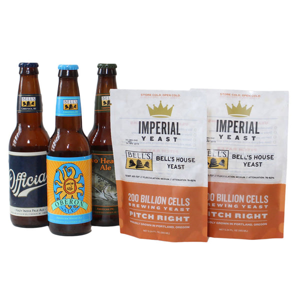 Three brown 12 oz beer bottles (from left to right: Official beer bottle with navy and off white logo label and Black label on the neck with yellow, black and white Bell's logo; Oberon beer bottle with blue, mint green, yellow and orange Oberon label with Oberon sun, and blue label on the neck with yellow, black, and white Bell's logo; Two Hearted Aled bottle with Two Hearted logo on label and Bell's label on the bottleneck.) To the right of the bottles, two bags of Bell's House Yeast Imperial Yeast.