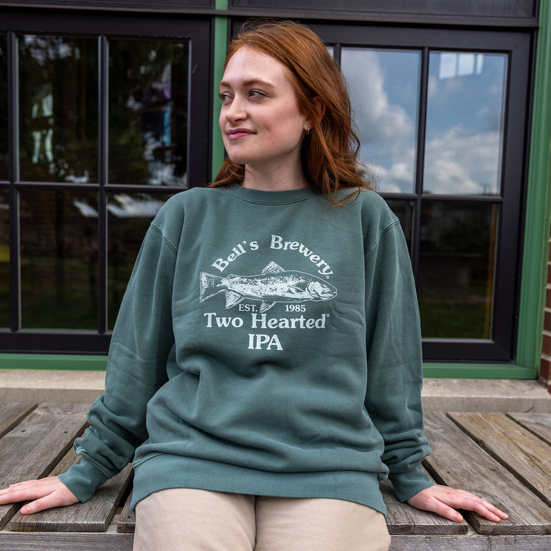 sage green long sleeve crew neck sweatshirt with light green Bell's Brewery Two Hearted Ale" logo, fish and est. 1985 across the chest.