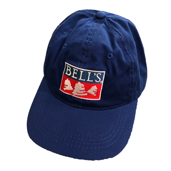 Navy blue dad hat with Bells logo in the center.  The lettering, bells, and the outlining box are white, and the bottom half of the box is red.