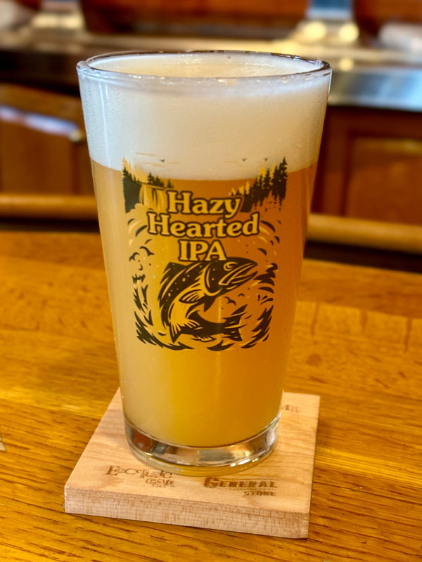 Clear pint glass featuring Hazy Hearted IP can art in yellow and navy.
