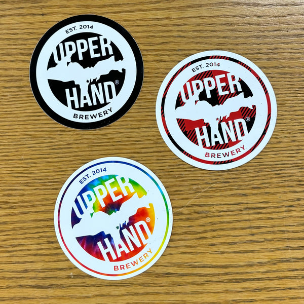 3 circular Upper Hand logo bumper stickers, in black, red plaid, and tie dye