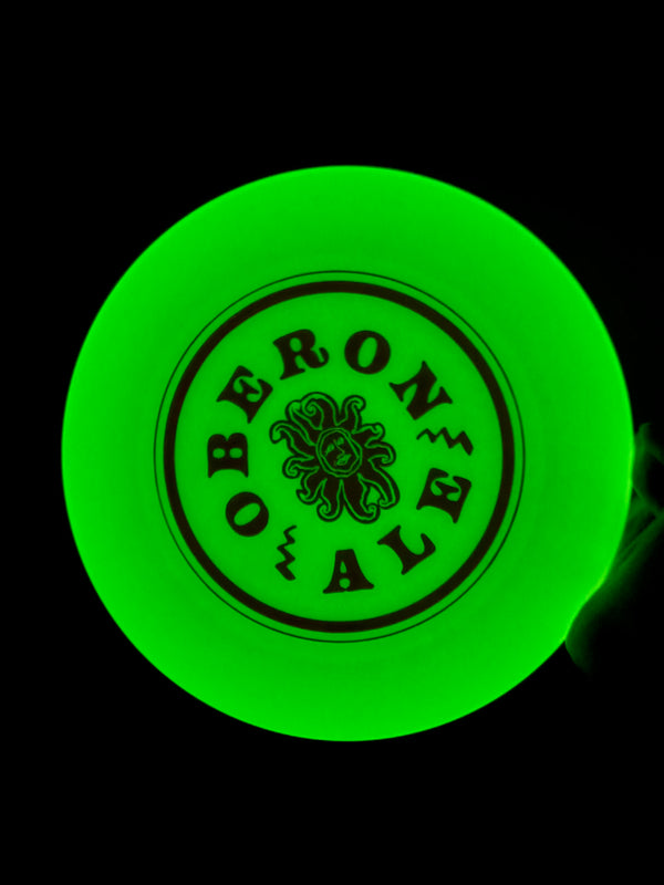 A green glowing ultimate disc with small Oberon sun surrounded by circular Oberon text.