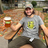 heathered gray short sleeve tee shirt with full color Hopslam logo on front center.  Image is large hop with man "crushed" beneath, with only arms and legs visible