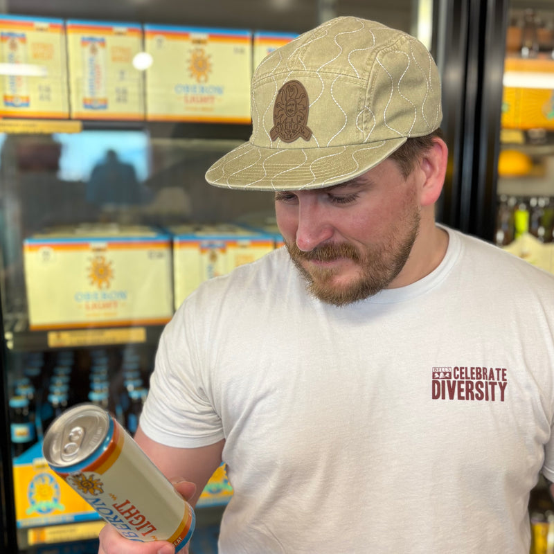 olive green 7 panel flat brim hat with white wave pattern stitching.  Also features leather patched stamped with Oberon logo
