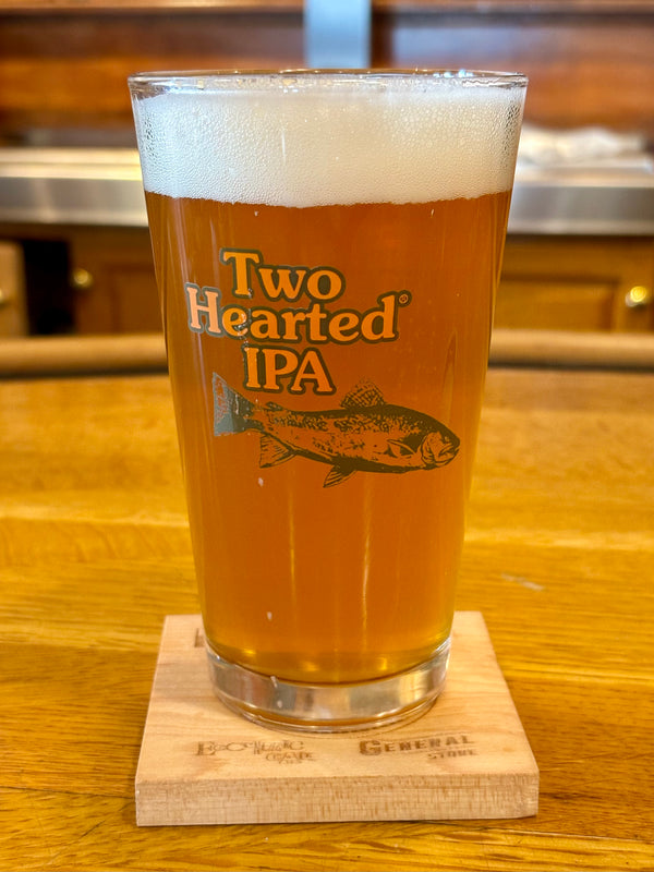Clear pint glass with green Two Hearted fish and a green Bell’s logo.
