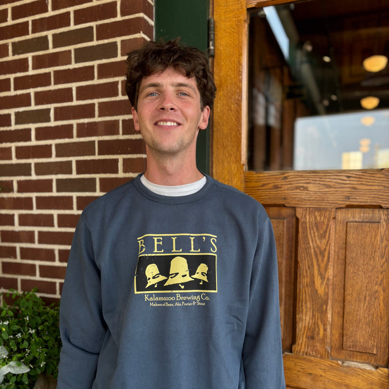blue sweatshirt with vintage black and yellow Bell's logo and tagline in yellow reads "Kalamazoo Brewing Co. Makers of Beer, Ale, Porter and Stout"