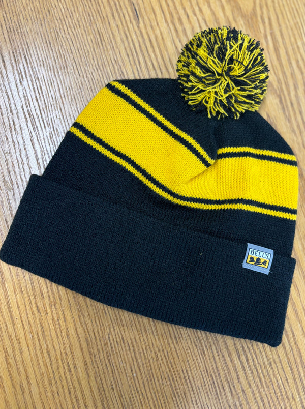 Black knit beanie with yellow stripes and a pom with black and yellow.  Also features a Bell's logo tag on the front.