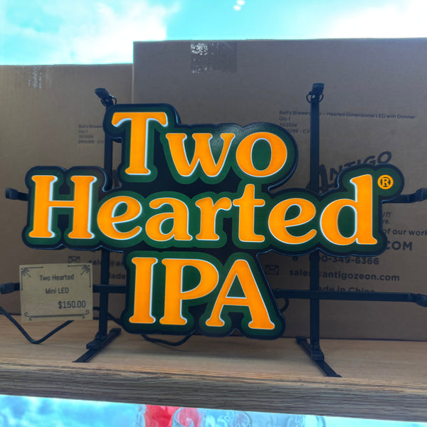 led light with orange lettered "Two Hearted IPA" logo traced in green led light. 