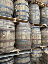 large round barrels stacked up. Used bourbon barrels for making barrel aged beers. 