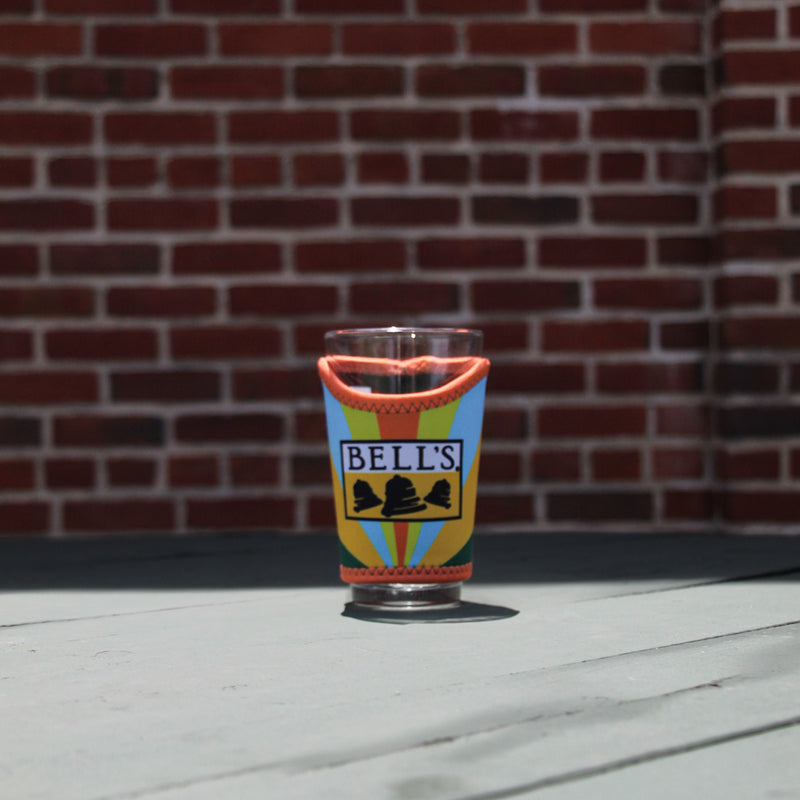 Multi-color glass pint sleeve with 'Bell's' on the sleeve.