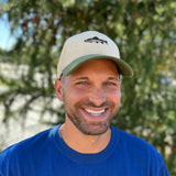 white corduroy hat with green corduroy bill, features full color fish front and center