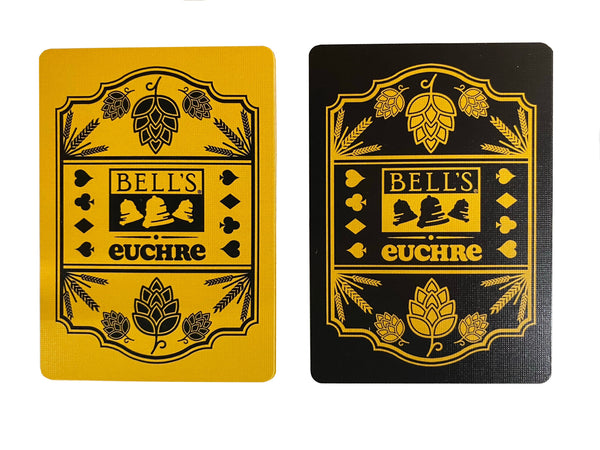 Two playing cards. On the left, a yellow card with black printing of Bell's logo, euchre, and barley and hops illustrations. On the right, a black card with yellow printing of Bell's logo, euchre, and barley and hops illustrations.