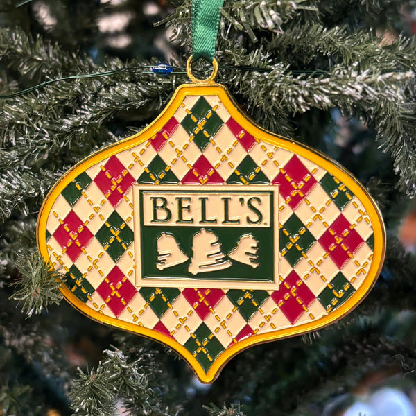 red and green argyle patterned metal ornament with  green Bell's logo in center and gold outline and stitch pattern