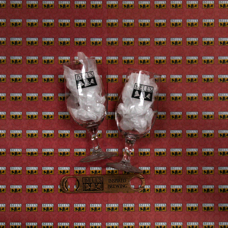 Two munique glasses with aBell's logo in black, anda wood grain style copper bottle opener with Bell's logo