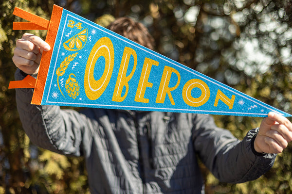 A blue triangle pennant flag with Oberon in yellow letters.