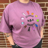Purple short sleeve tee shirt with multi colored glassware arranged in a circle around Celebrate Diversty in black at the center. Black Bell's logo in the center between Celebrate and Diversity.
