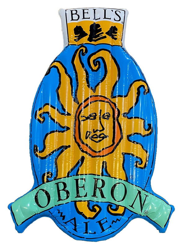 A pool float in the shape of the Oberon logo, featuring the Oberon Sun in yellow and the outer oval in blue.