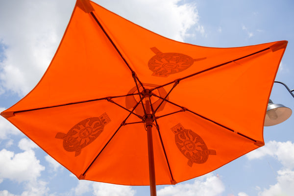 Orange beach umbrella with Oberon Ale logo