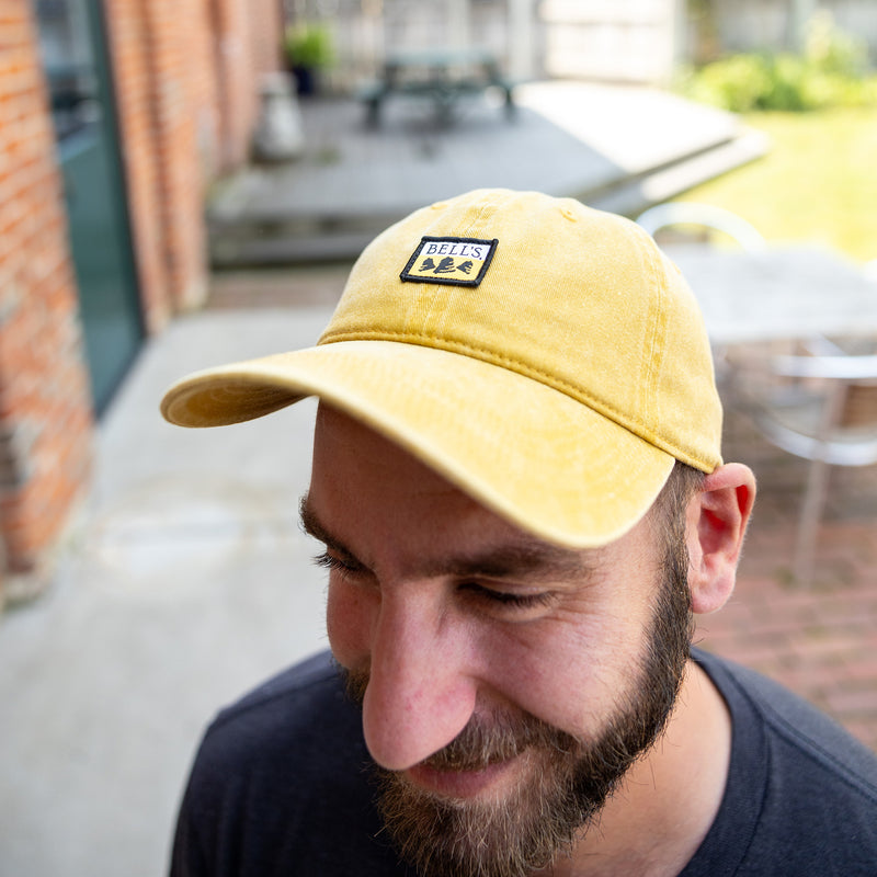 mustard colored dad hat with small full color Bell's logo patch on front