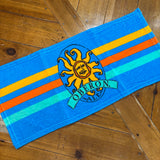 Blue bar towel with teal orange and yellow stripes and full color Oberon sun logo