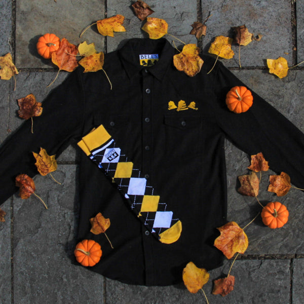 black western cut long sleeve button up flannel with yellow embroidered Bells above left pocket, and pair of yellow, black. and white argyle socks with black bell's logo near top
