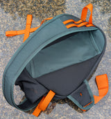 back of green, black and orange fly fishing bag.