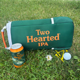 wide view of backside green cooler bag with white zipper and accents, and orange handle.  with large Two Hearted IPA in orange text across bag