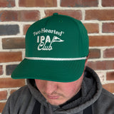 Person wearing a green baseball hat with 'two hearted IPA Club' in white. the b in club is a pendant flag with fish outline