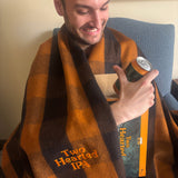 orange buffalo check wool blanket with brighter orange embroidered "Two Hearted IPA" on bottom right corner