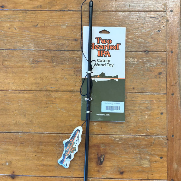 Catnip wand toy with 'Two Hearted IPA' packaging on a wooden surface, toy is shaped like Two Hearted Fish logo