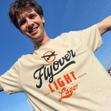 beige short sleeve tee with dark blue and orange Flyover Light Lager logo and text on front. 
